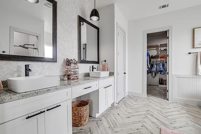 a bathroom with a sink double vanity and a mirror