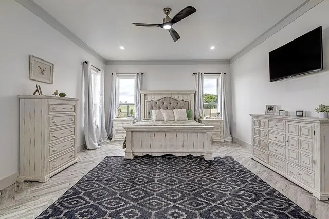 a bedroom with a bed and flat screen tv