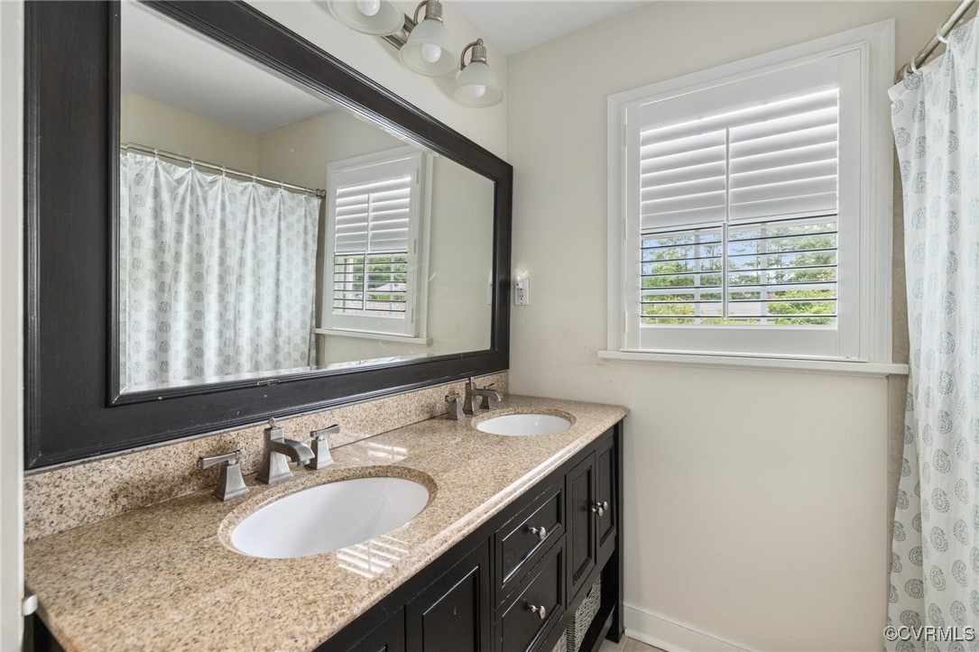 8950 Bellefonte Road Henrico, VA 23229 - Photo 39 of 50 Hall Bathroom with Double vanity and Tiled tub/sho