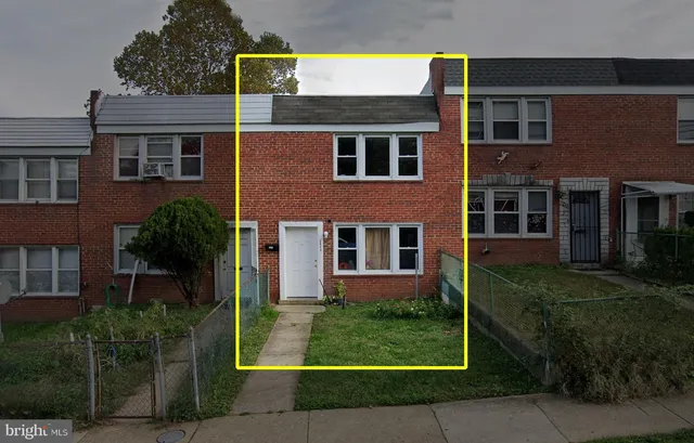 a view of a brick building next to a yard