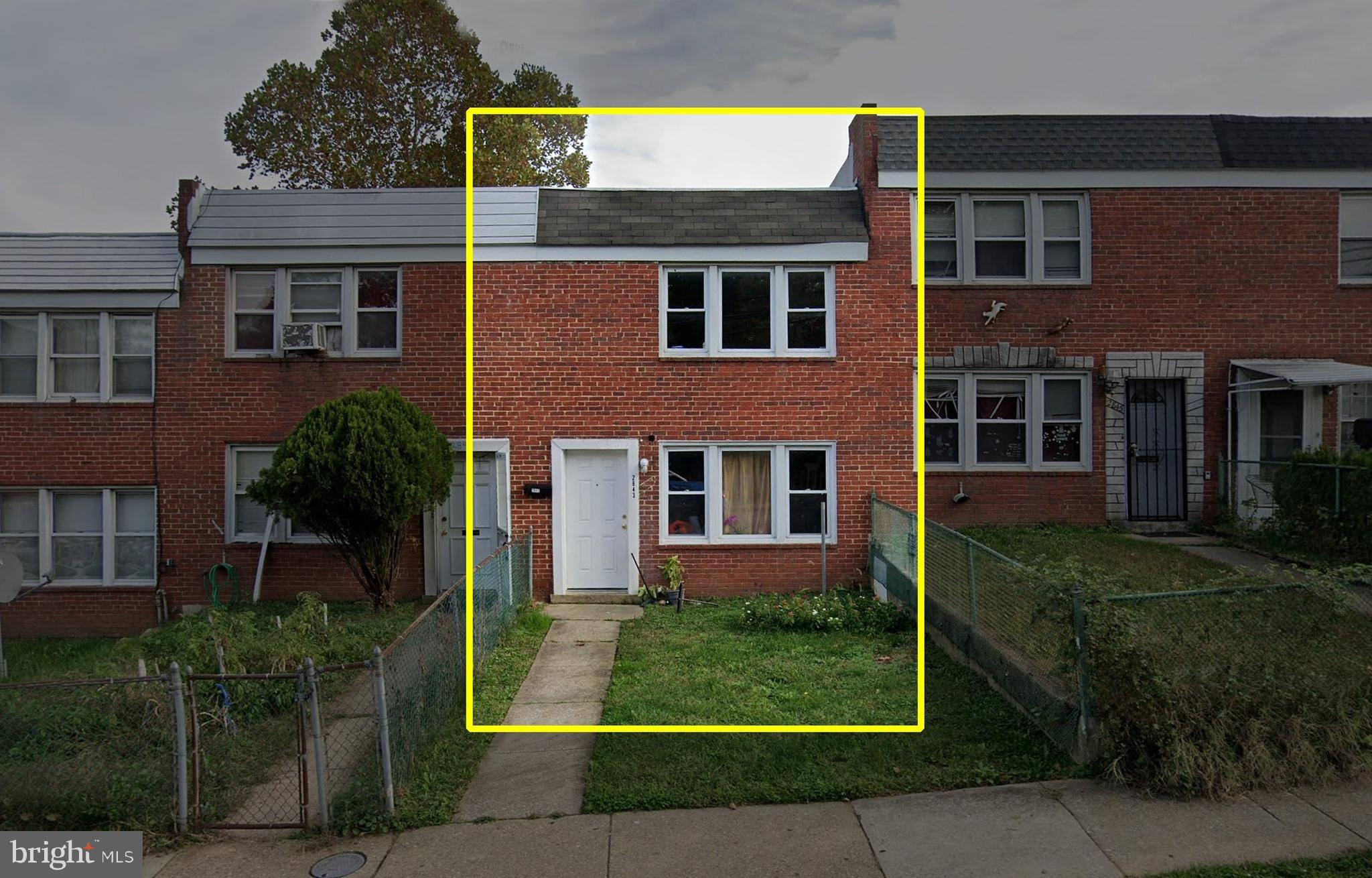a view of a brick building next to a yard