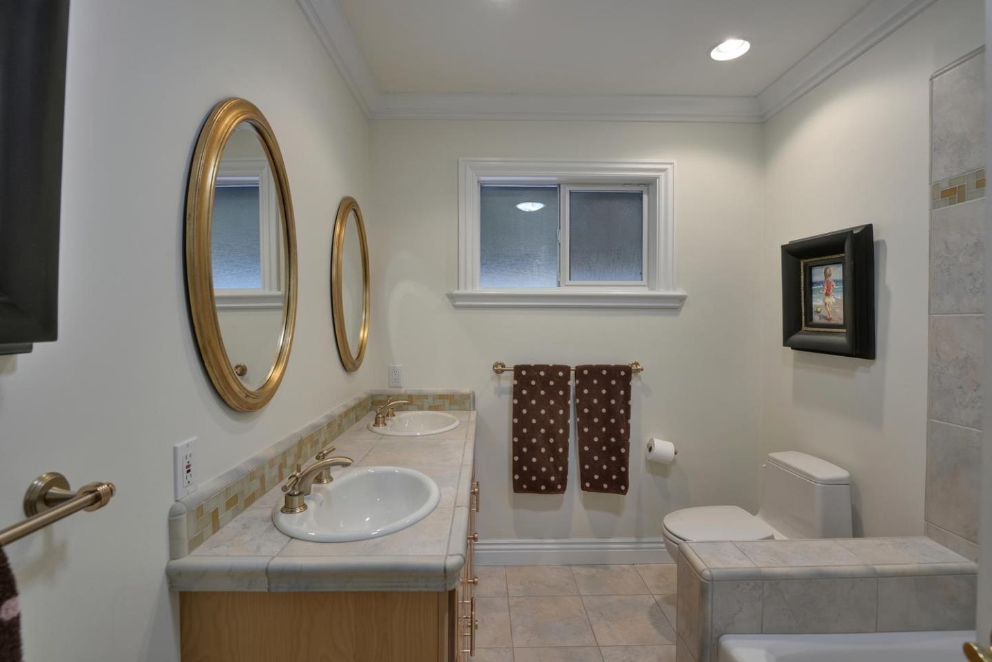 815 Patrol Road Woodside, CA 94062 - Photo 13 of 16 a bathroom with a toilet sink and mirror