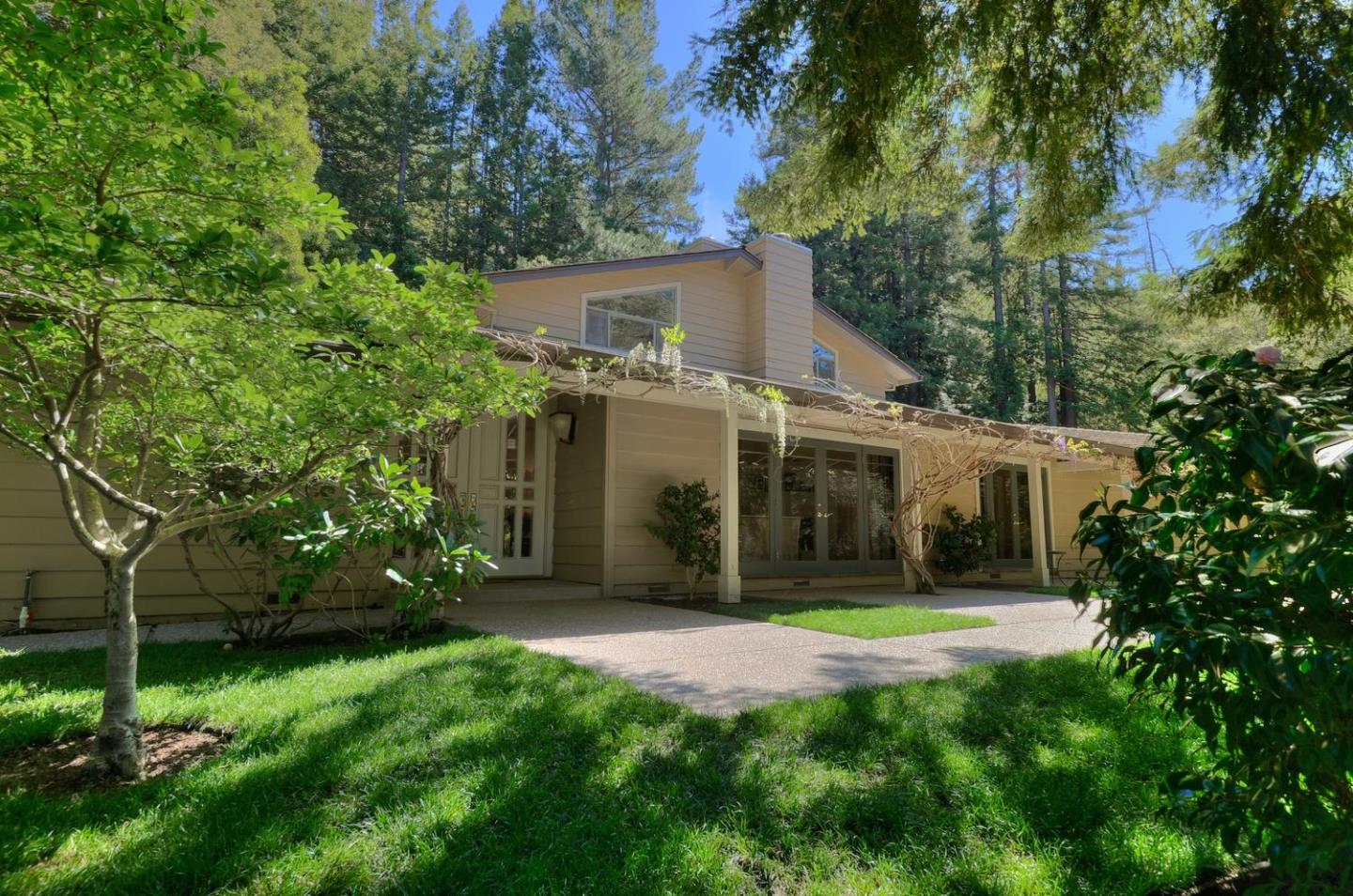 815 Patrol Road Woodside, CA 94062 - Photo 2 of 16 a view of a house with brick walls and a tree