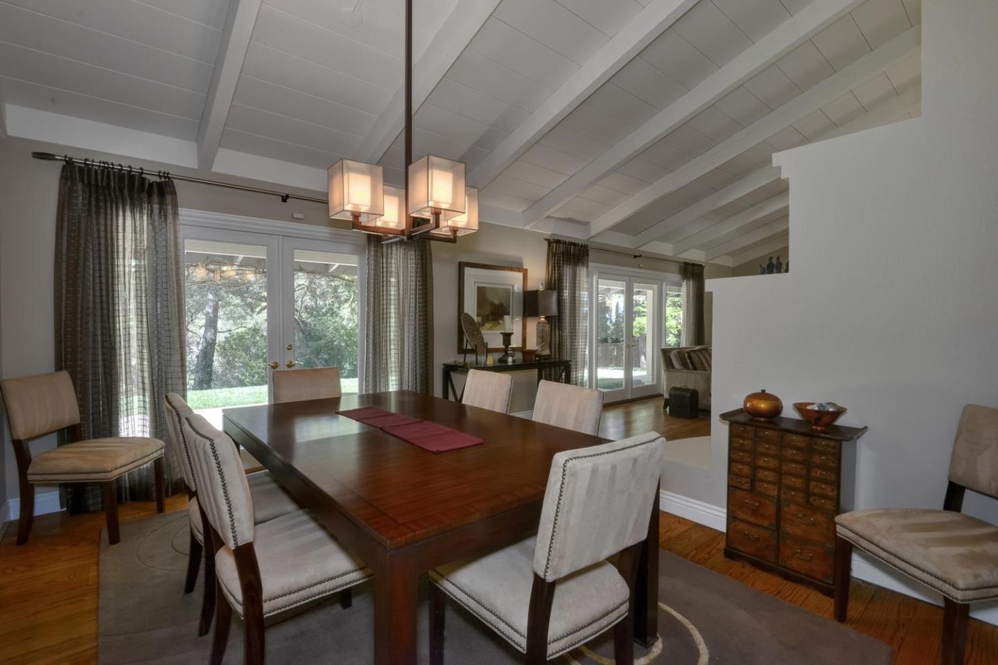 815 Patrol Road Woodside, CA 94062 - Photo 4 of 16 a dining room with wooden floor a chandelier a wooden table and chairs