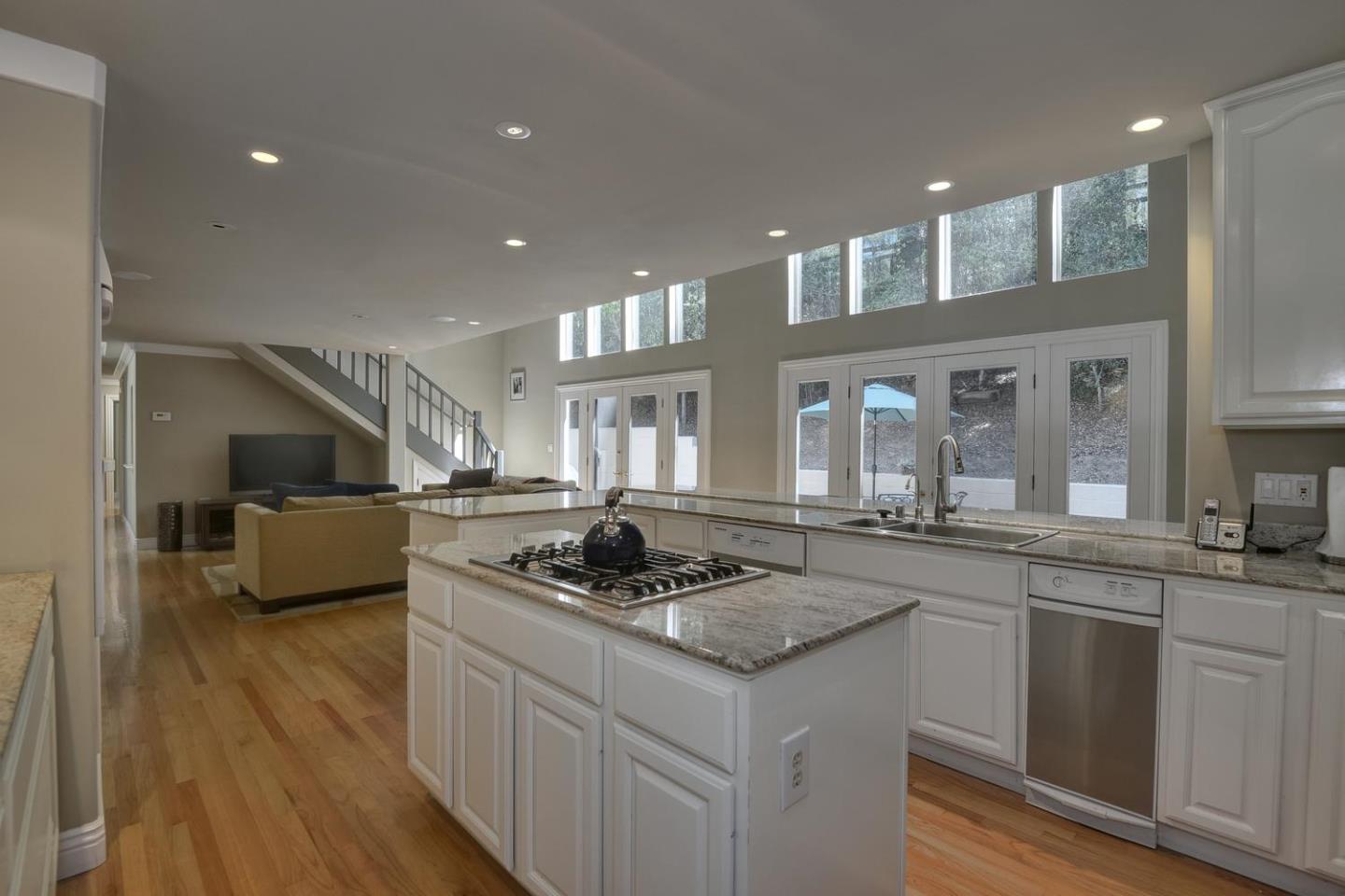 815 Patrol Road Woodside, CA 94062 - Photo 5 of 16 a kitchen with stainless steel appliances granite countertop a sink stove and cabinets
