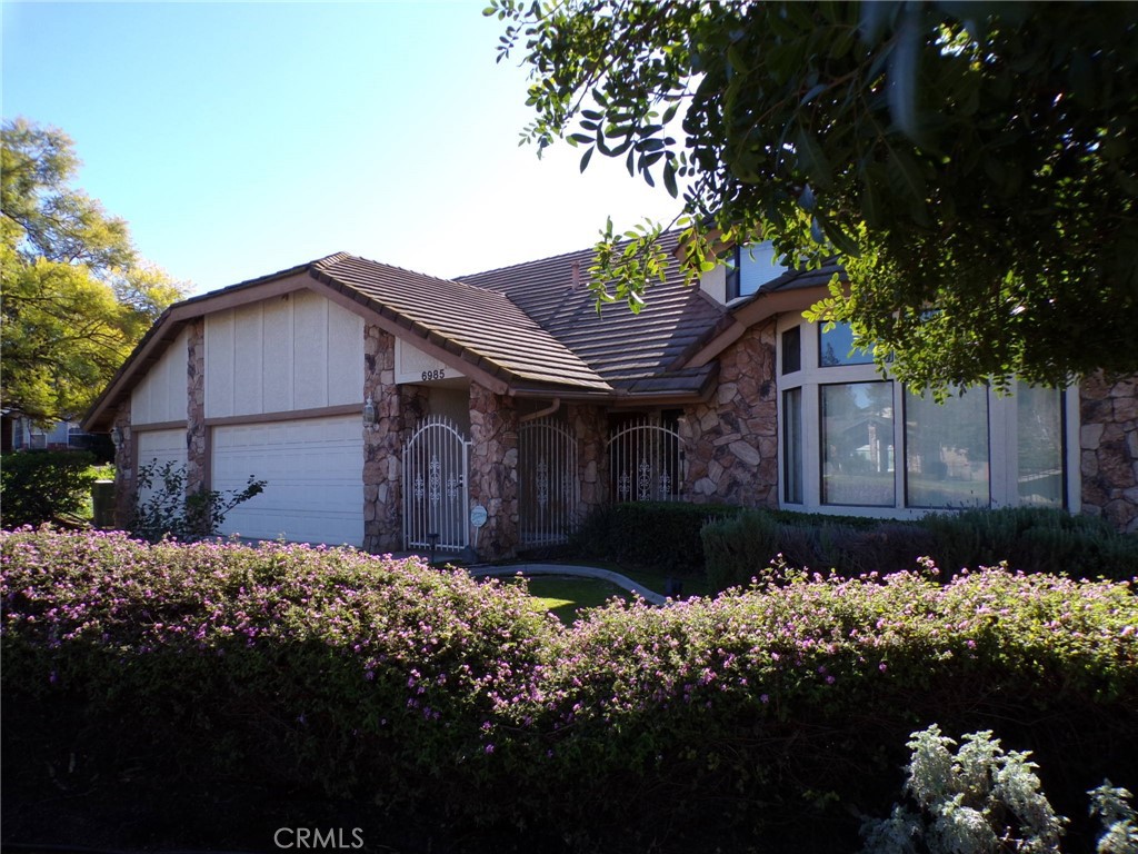 6985 Withers Road Riverside, CA 92506 - Photo 2 of 11 a front view of house with a yard covered with green space
