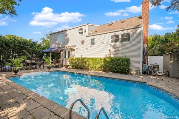 a swimming pool with outdoor seating and yard