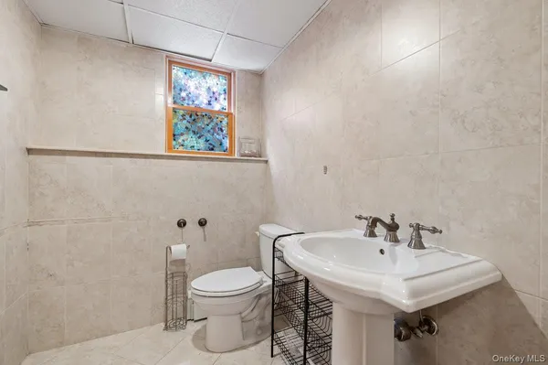 a bathroom with a sink a toilet and mirror