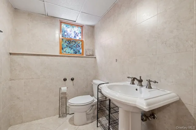 a bathroom with a sink a toilet and mirror