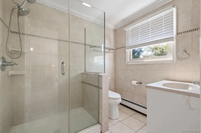 a bathroom with a granite countertop bathtub shower sink and toilet