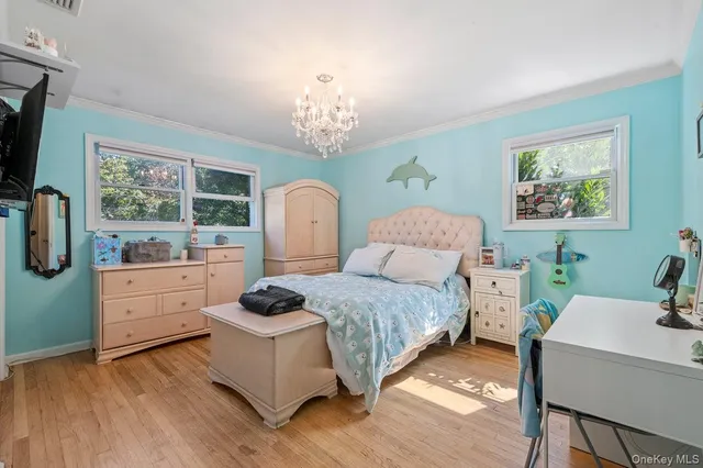 a spacious bedroom with a bed and a dresser