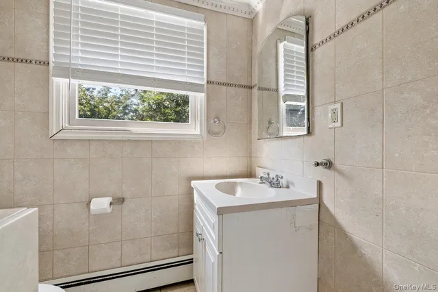a bathroom with a sink a window and shower