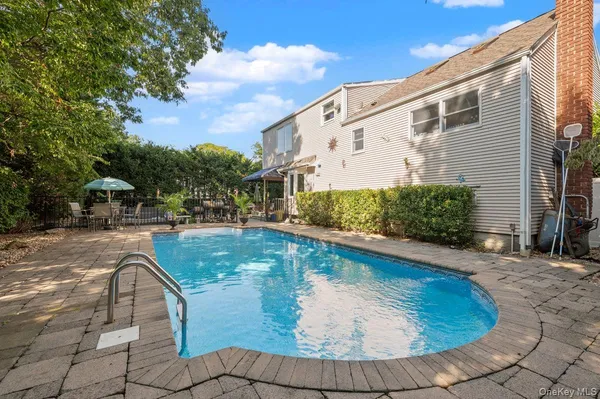 a view of swimming pool with outdoor seating