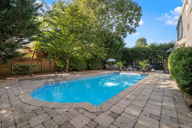 a view of a swimming pool with sitting area
