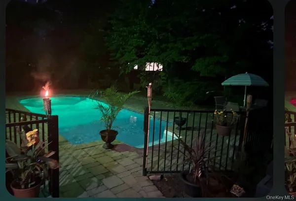 a view of a balcony with a floor to ceiling window and potted plants