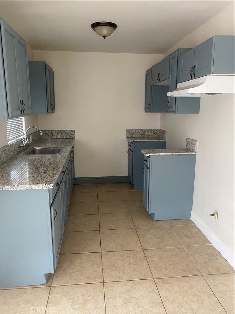 2030 West El Segundo Boulevard Gardena, CA 90249 - Photo 4 of 4 a kitchen with a sink a stove top oven and cabinets