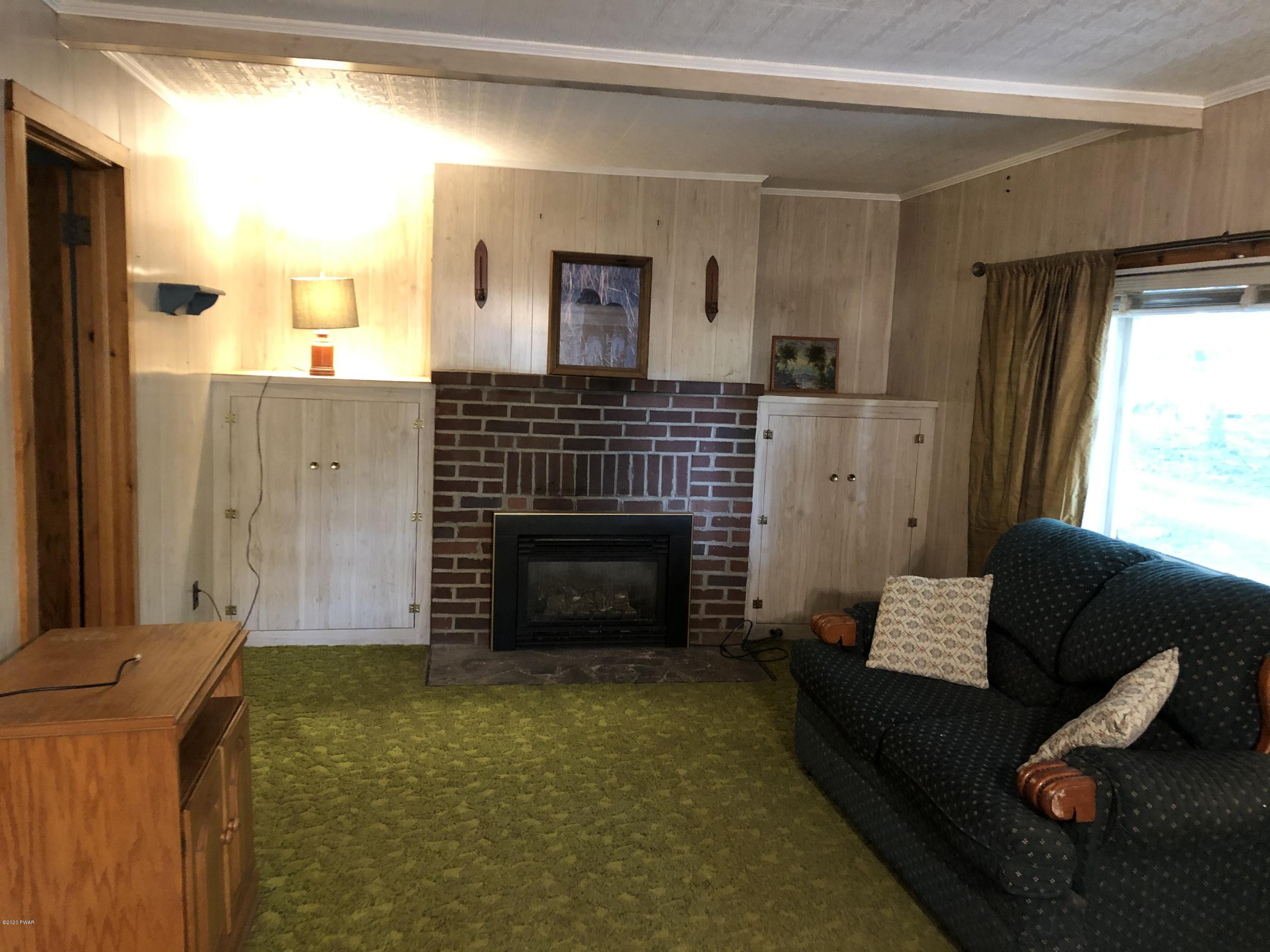 45 W Road Hawley, PA 18428 - Photo 8 of 19 a living room with furniture and a fireplace