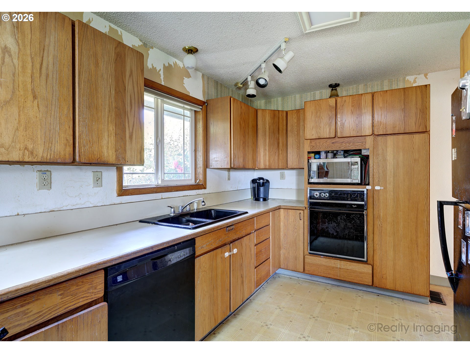 1703 Allen Street Kelso, WA 98626 - Photo 3 of 23 a kitchen with stainless steel appliances a sink cabinets and a window