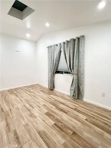 a view of a room with a bed and cabinets
