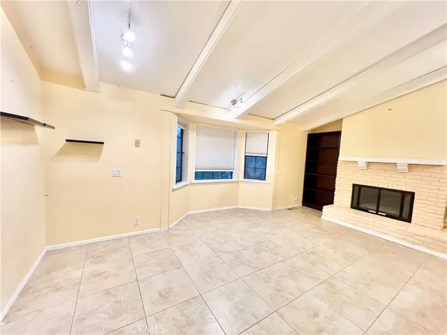 a view of an empty room with a fireplace