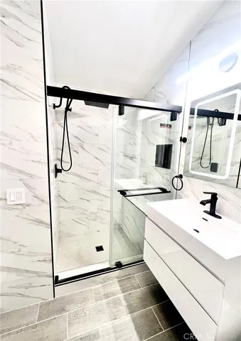 a kitchen with a sink a refrigerator and cabinets
