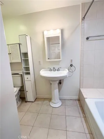 a bathroom with a sink toilet and a mirror
