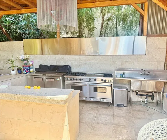 a kitchen with a stove a sink and cabinets