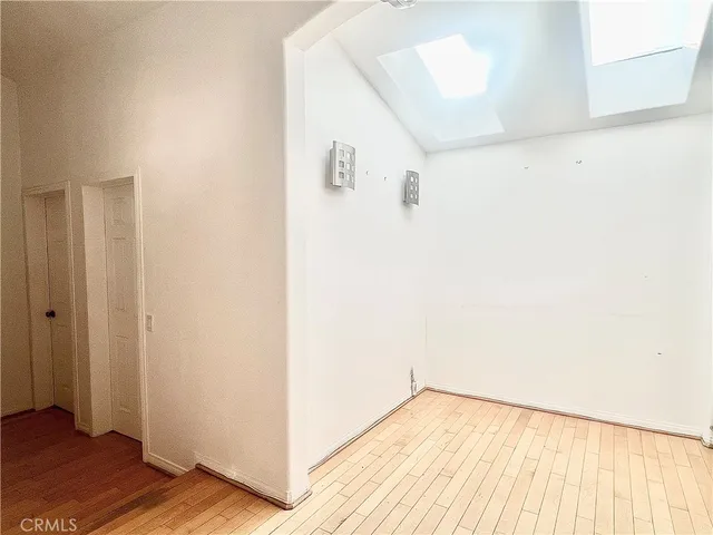 a view of a room with wooden floor and small space