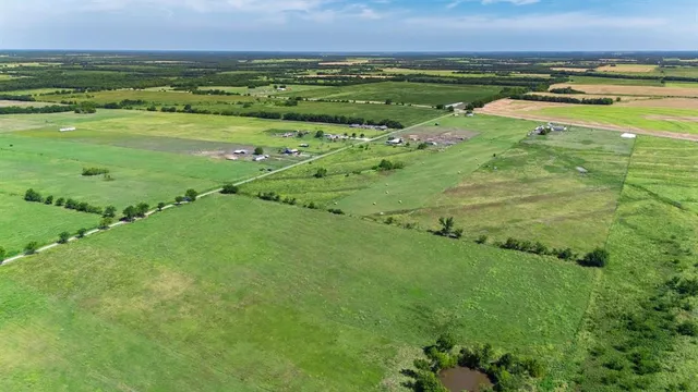 a view of a field with an ocean
