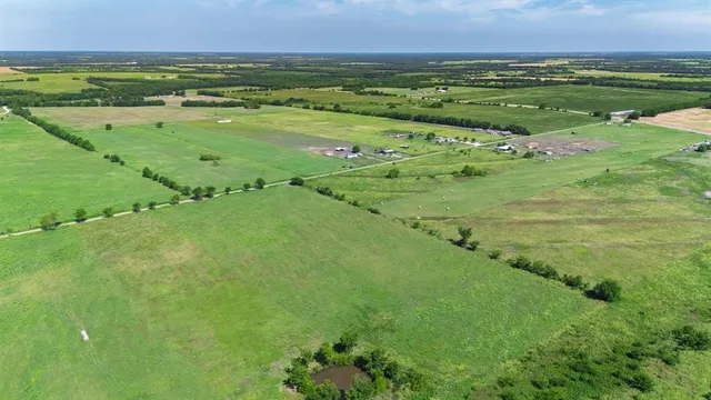 a view of a field with an ocean