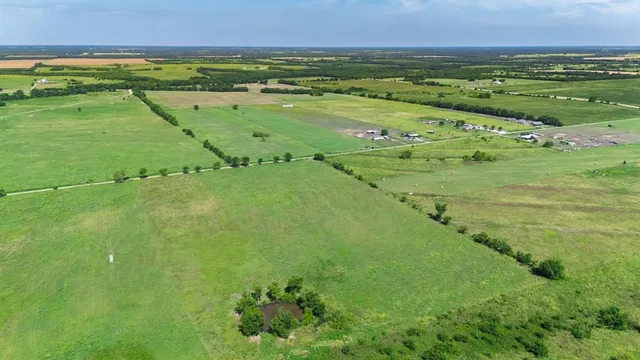 a view of a field with an ocean
