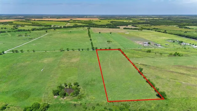 a view of a field with an ocean