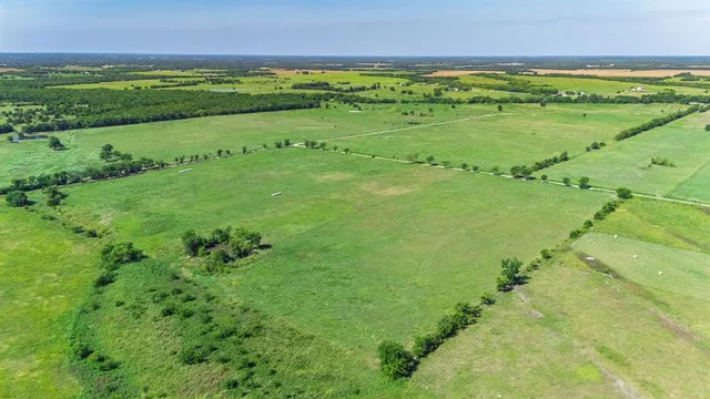 a view of a field with an ocean view