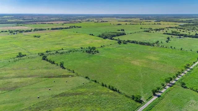 a view of a field with an ocean