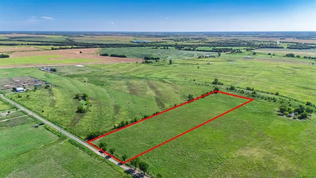 a view of a field with an ocean