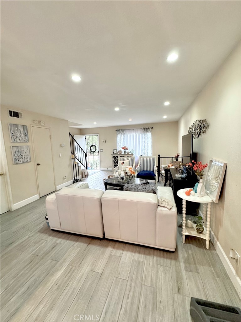 13450 Meyer Road, Unit 33 Whittier, CA 90605 - Photo 3 of 10 a living room with furniture and a wooden floor