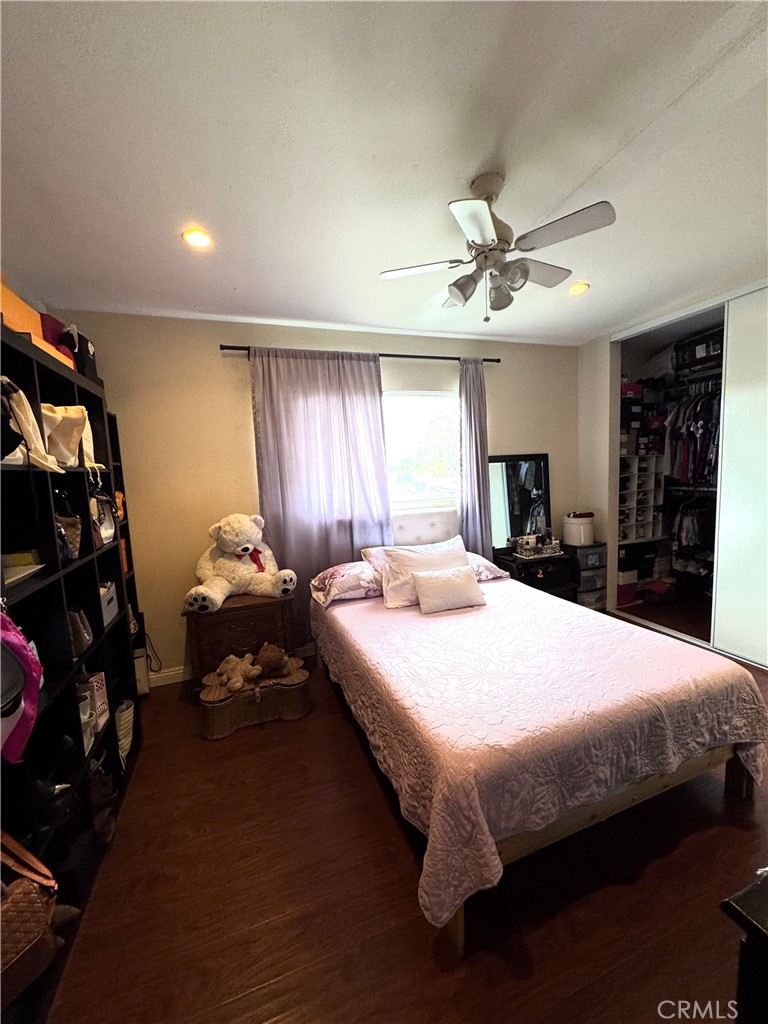 13450 Meyer Road, Unit 33 Whittier, CA 90605 - Photo 7 of 10 a bed sitting in a bedroom next to a window and a chandelier