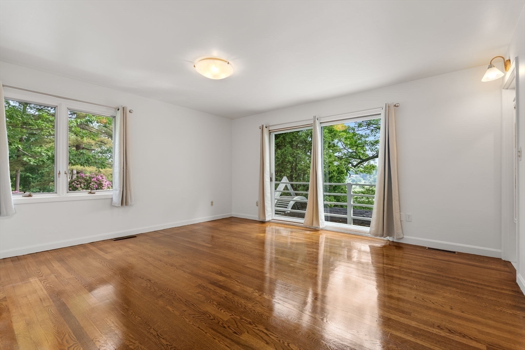 23 Ocean Street Manchester, MA 01944 - Photo 25 of 36 a view of an empty room with wooden floor and a window