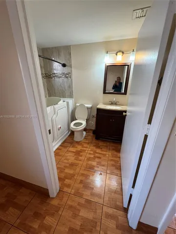 a view of an empty room and wooden floor