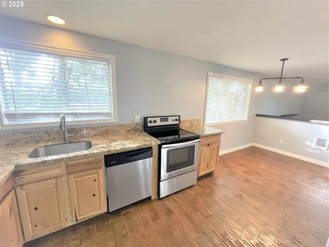 a kitchen with a sink and large window