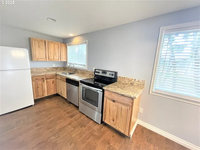 a kitchen with a stove and a white refrigerator