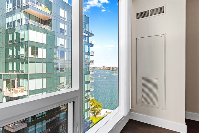 a bedroom with a large bed and a large window