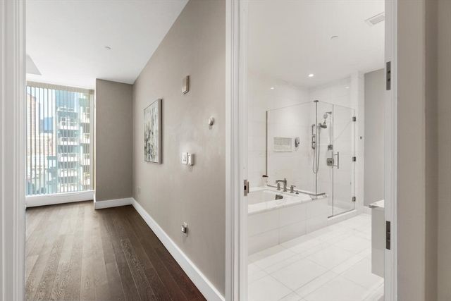 a bathroom with a tub sink and mirror