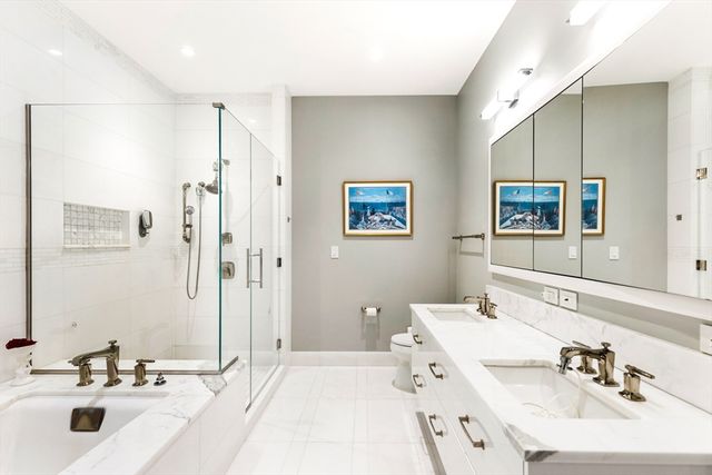 a bathroom with a tub sink and mirror