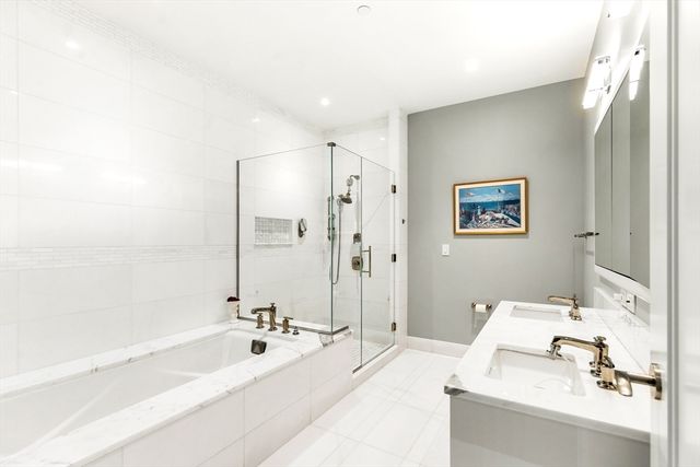 a bathroom with a bathtub and a shower