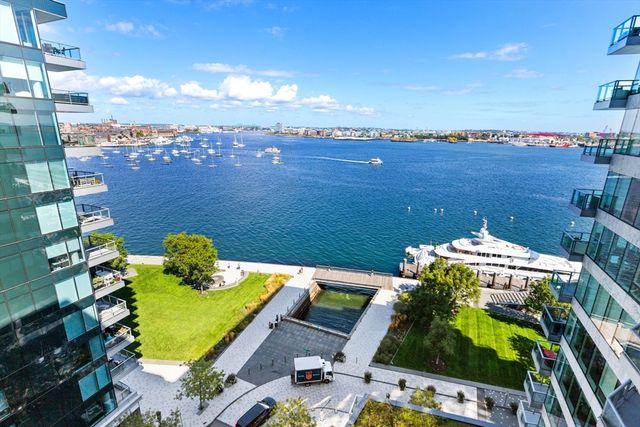 a living room with furniture and view of kitchen
