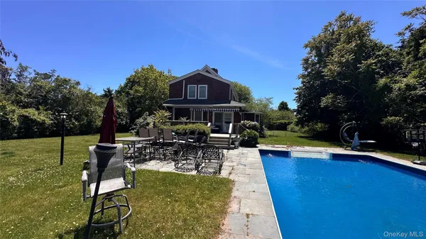a view of a swimming pool with chairs in patio