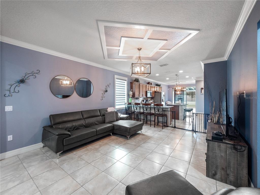 3570 Southern Cross Loop Kissimmee, FL 34744 - Photo 11 of 36 a living room with furniture and a flat screen tv