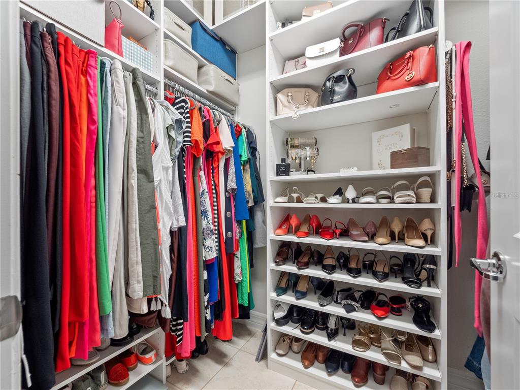 3570 Southern Cross Loop Kissimmee, FL 34744 - Photo 17 of 36 a view of walk in closet with clothes and shoes