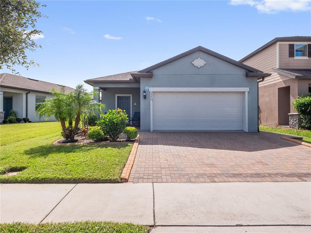 3570 Southern Cross Loop Kissimmee, FL 34744 - Photo 3 of 36 a front view of a house with a yard and garage